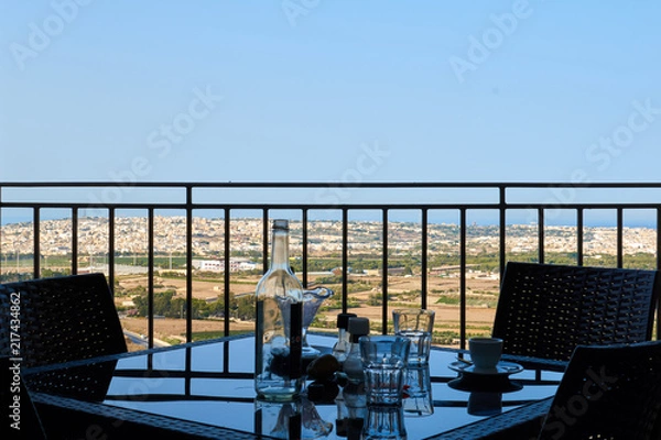 Fototapeta Cafe in medieval Mdina with Malta landscape behind