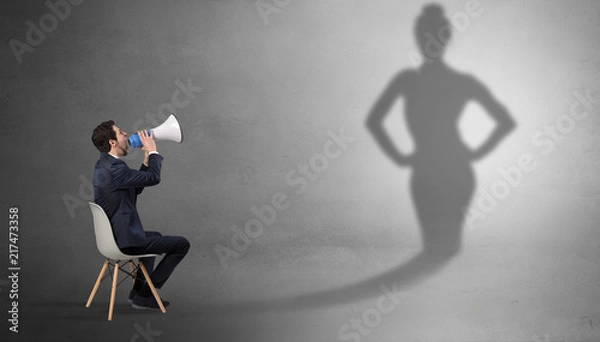 Fototapeta Rich businessman staying and offering stuffs to a pretty shadow woman
