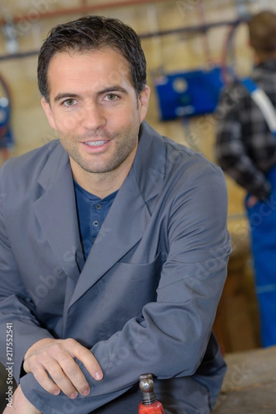 Fototapeta mechanic posing in workshop