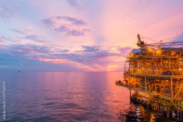 Fototapeta Offshore construction platform for exploration and production oil and gas with bridge in evening time for power energy of the world concept