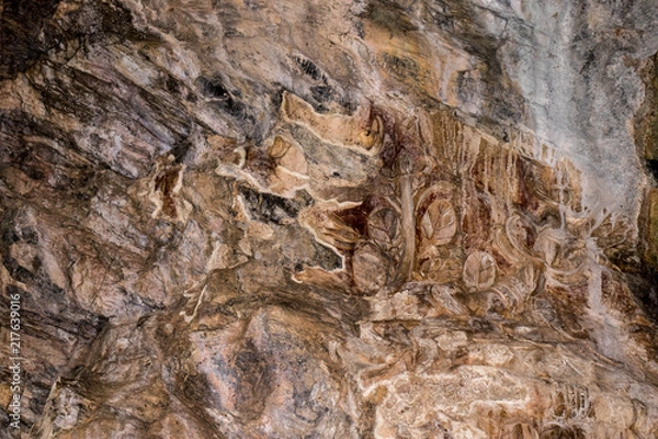 Fototapeta Ancient carved in the wall of the cave.