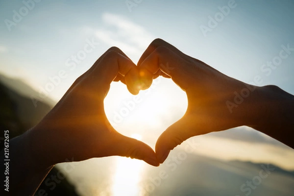 Obraz Two hands making heart shape in sky