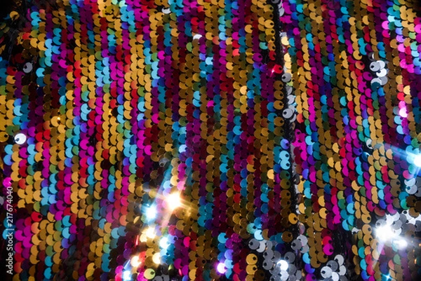Fototapeta sequins colorful on the fabric. Texture scales of round sequins 