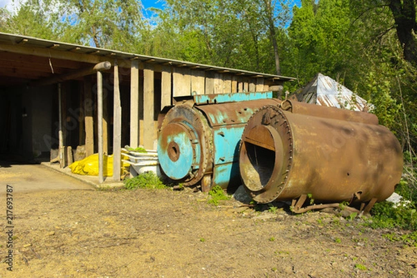 Obraz Old abandoned iron rusty tanks and metal structures. The crisis, the collapse of the economy, the cessation of production capacity, led to a collapse. The global catastrophe.