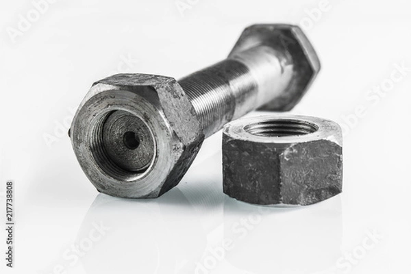Fototapeta bolt and nut lying on a white background