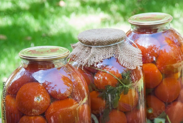 Fototapeta Canning tomatoes in glass jars with spices
