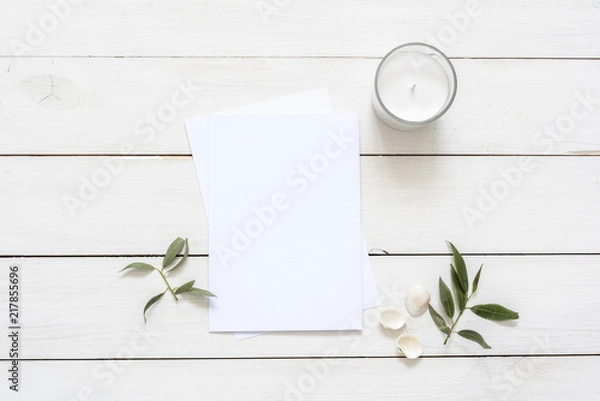Fototapeta Stylish flat lay with card blank space, stationary, candle, seashells, leaves. Ready to insert your text, invitation, wedding or logo. Best for social media, backgrounds, headers, blogs, wedding
