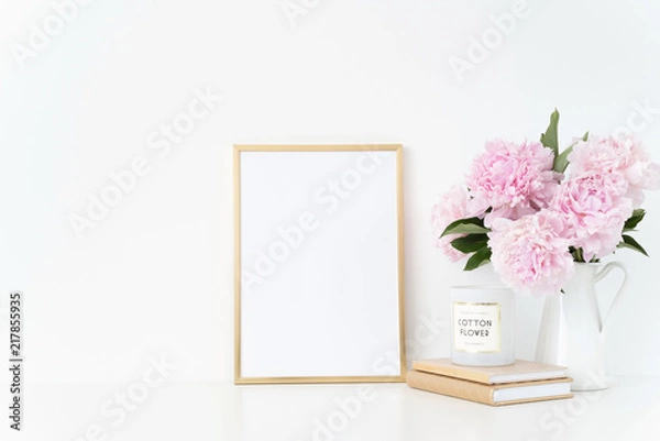 Fototapeta Elegant gold portrait a4 frame mock up with a pink peonies in white jug. Overlay your quote, promotion, headline, or design, great for small businesses, lifestyle bloggers and social media campaigns
