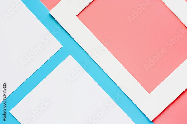 Fototapeta White paper frame on pink-blue pastel color background. Flat lay and top view image.