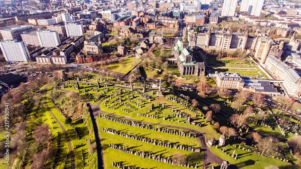 Fototapeta Aerial image of a low sun casting long shadows in Glasgow Necropolis. Victorian garden cemetery adjacent to Glasgow Cathedral.
