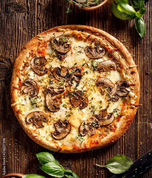 Fototapeta Mushroom pizza with addition mozzarella cheese and herbs on a wooden table, top view
