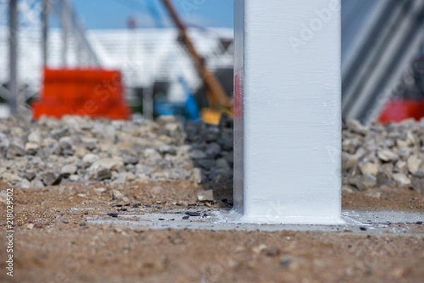 Obraz Industrial construction site of new shopping mall in a city. Reinforced concrete piles foundation for the building. Freshly made grouting base pole for block building