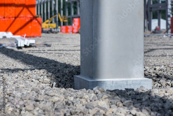 Obraz Industrial construction site of new shopping mall in a city. Reinforced concrete piles foundation for the building. Freshly made grouting base pole for block building