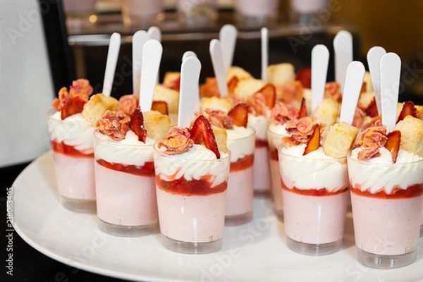 Obraz A tray of strawberry parfait desserts ready to be served.