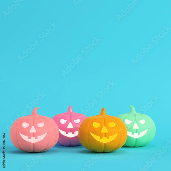 Obraz Four colorful halloween pumpkins, jack o lantern on bright blue background in pastel colors