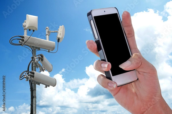 Fototapeta Cellular network antenna and handphone and blue sky.