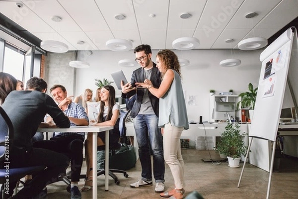 Fototapeta Business creative people showing teamwork in the office interior. Business concept. Teamwork.