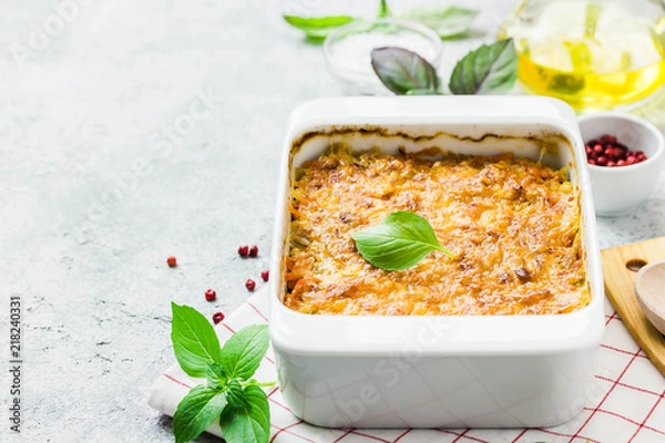 Obraz Cheddar cabbage roll casserole on concrete background. Selective focus, space for text.