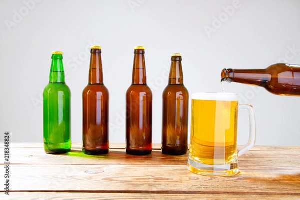 Fototapeta glass of beer on wooden table, top view. Beer bottles. Selective focus. Mock up. Copy space.Template. Blank.