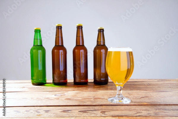 Fototapeta glass of beer on wooden table, top view. Beer bottles. Selective focus. Mock up. Copy space.Template. Blank.