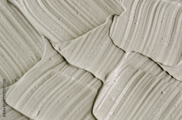 Obraz Gray cosmetic clay (kaolin) texture close up, selective focus. Abstract background with brush strokes. 