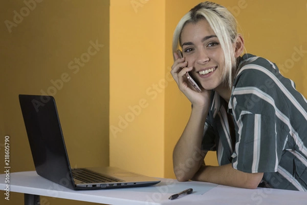Fototapeta Office worker looking at camera with phone