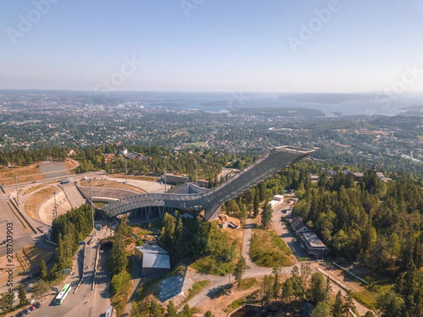 Fototapeta Aerial of Holmenkollen  Ski Museum and Ski Jump Tower in Oslo, Norway. Oslofjord can be seen in far distance