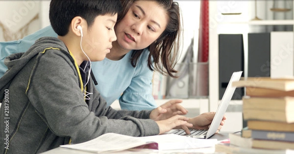 Obraz Cute asian mother helping your son doing your homework .