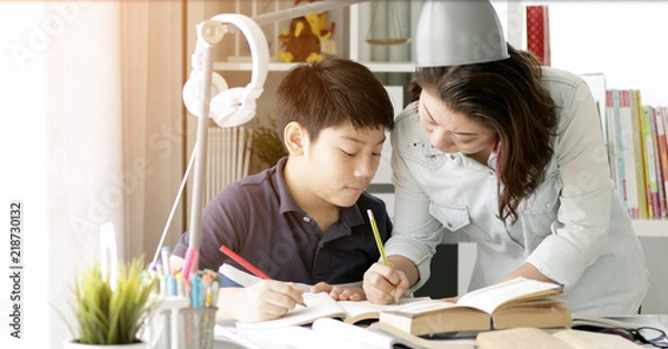Obraz Cute asian mother helping your son doing your homework .