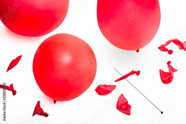 Obraz Old fashioned hat pin and a collection of popped and inflated red balloons.