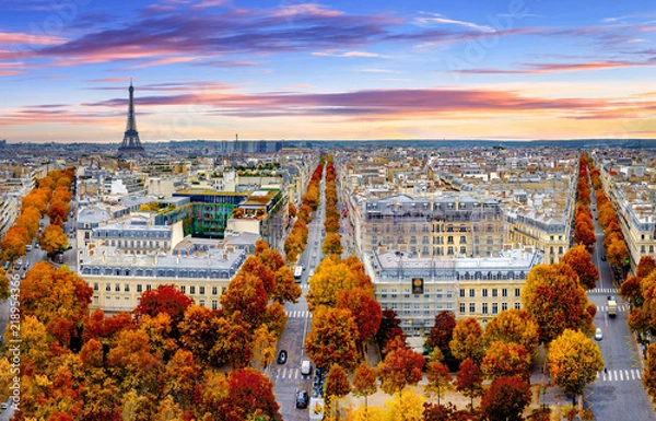 Fototapeta Aerial view of Paris in late autumn at sunset.Red and orange colored street trees. Eiffel Tower in the background. Paris, France