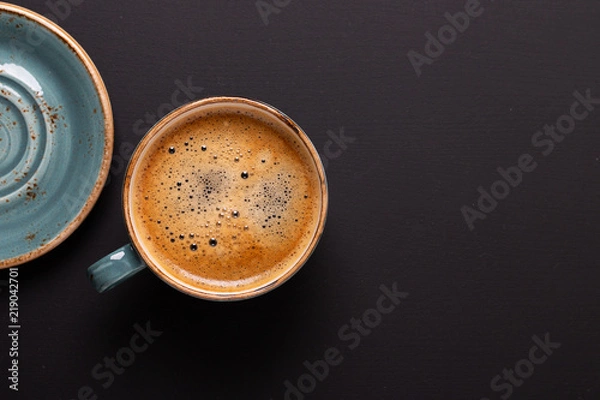 Obraz Cup of coffee on black background. Copy space. Top view. Flat lay.