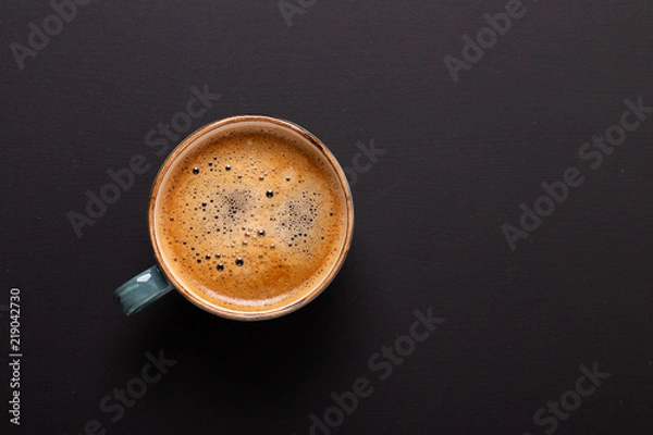 Obraz Cup of coffee on black background. Copy space. Top view. Flat lay.