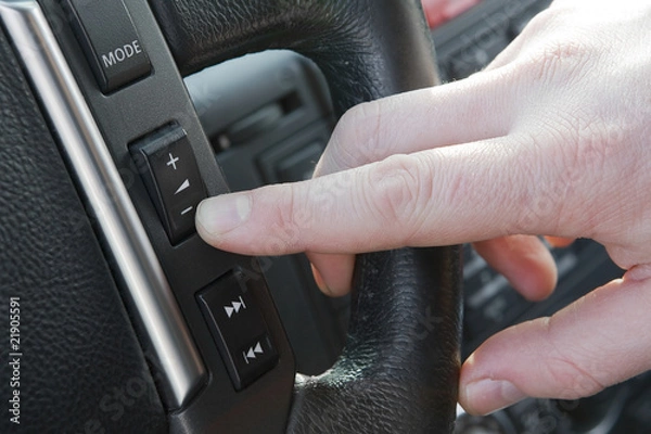 Obraz Finger pushing reduce volume button