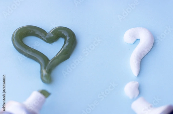 Fototapeta Heart symbol and question mark from toothpaste. Concept of dental care