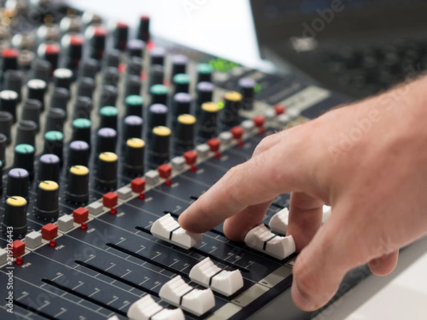 Fototapeta Audio engineer working on mixing console
