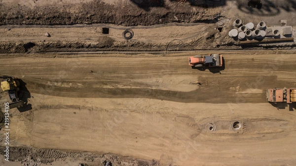Fototapeta Aerial construction site with machinery. Top down view of city building site.
