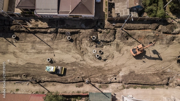 Fototapeta Aerial construction site with machinery. Top down view of city building site.
