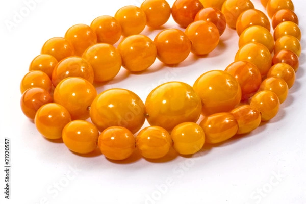 Obraz Amber chaplet lying on a white surface