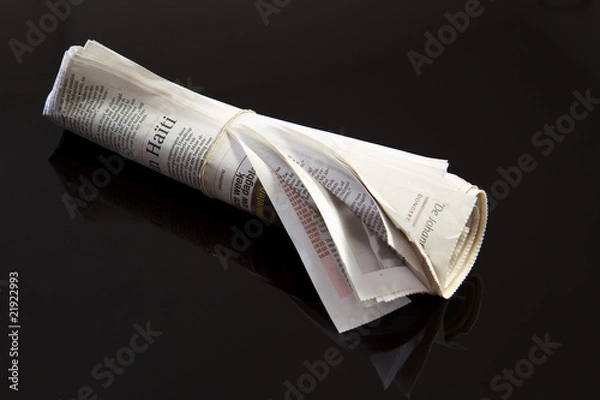 Obraz rolled up newspaper on black