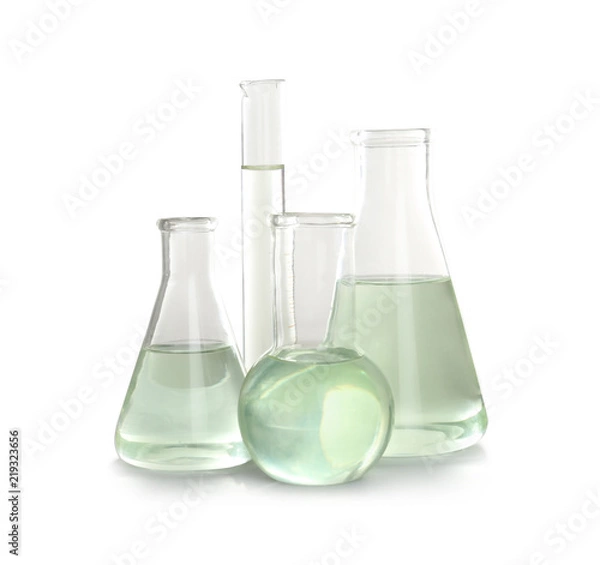 Fototapeta Laboratory glassware with liquid on white background. Chemical analysis