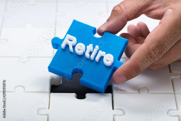 Fototapeta Person placing last retire piece into jigsaw puzzle