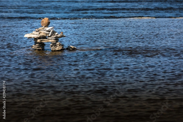 Obraz Inukshuk by the river edge.