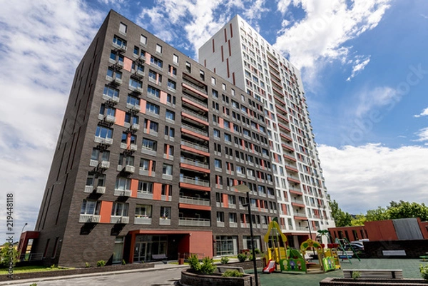 Fototapeta The facade of a modern high-rise multi-storey apartment building in Moscow with balconies
