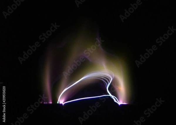 Fototapeta Electric arc between two electrodes seen on a black background.