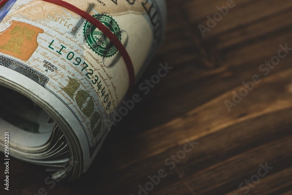 Obraz US dollars in roll on money background