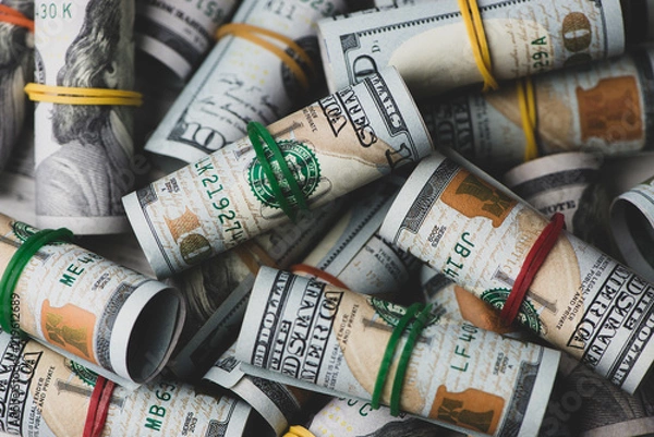 Obraz US dollars in roll on money background