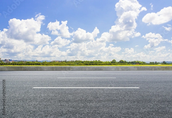 Fototapeta On the vast grassland, the asphalt road is clean and unmanned