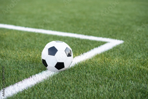 Fototapeta Traditional soccer ball on soccer field. black and White Soccer ball on green meadow