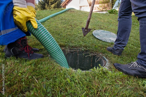 Fototapeta Emptying household septic tank. Cleaning and unblocking clogged drain.